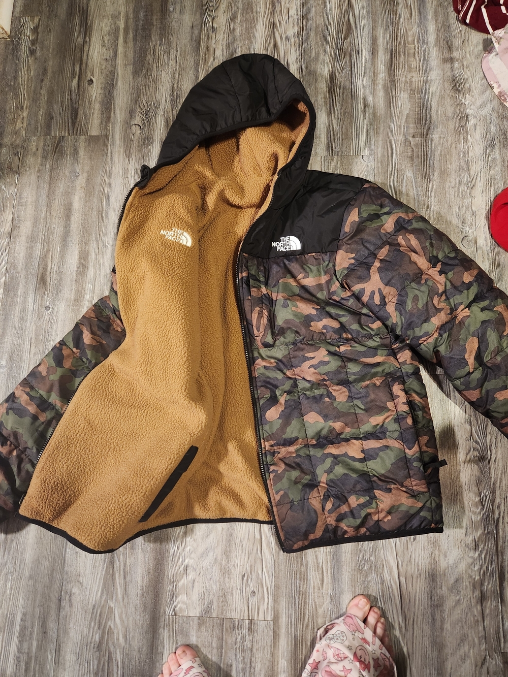 The North Face Kids Camo Puffer Jacket with Black Hood and Tan Sherpa Lining